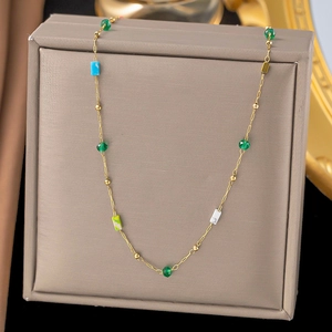 Dettaglio della collana in acciaio al titanio con perle dorate e perline in pietra colorata