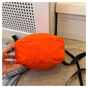Close-up of orange bucket bag reinforced base with premium nylon stitching details