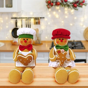 Close-up of plush gingerbread man figurines with chef hats and warm Christmas theme decor