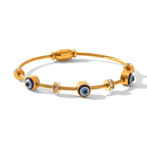 Detail of gold cable bracelet featuring evil eye beads and sparkling zircon spacers