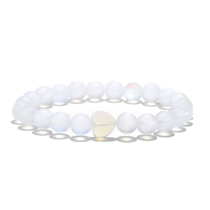 Detail of beaded bracelet with translucent white stones and a heart-shaped centerpiece