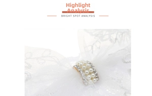Detail showing white lace headband with elegant pearls and rhinestone embellishments