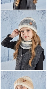 Close-up of winter knitted baby hat and neck warmer with striped pattern and leather tag