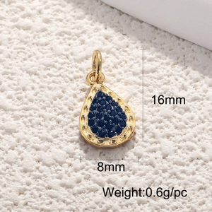 Macro detail of 18K gold-plated teardrop pendant with blue zircon stone, 16mm x 8mm