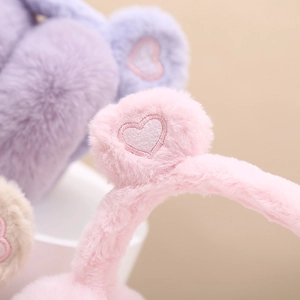 Plush heart earmuffs in pink and purple with soft faux fur for winter warmth and comfort
