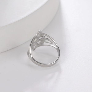 Elegant S925 sterling silver ring featuring a hollow bow-knot design on a white platform