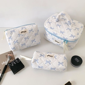 Three-piece quilted makeup bag set with blue bow pattern and hisocute label
