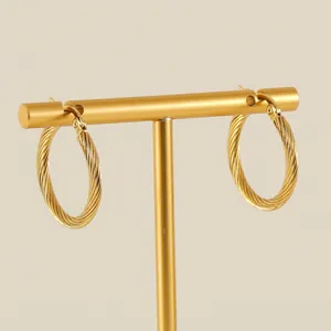 French vintage gold twisted hoop earrings made of titanium steel on a T-shaped stand