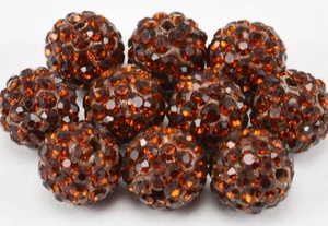 Macro view of stacked amber Shamballa beads with hand-set sparkling crystals