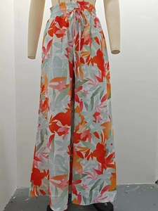 Detail view of the drawstring elastic waistband on colorful print wide-leg trousers