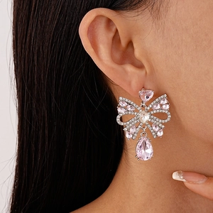 Pink teardrop crystal bow earrings with silver needles and micro-set cubic zirconia