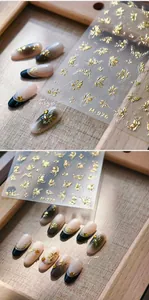 Detail of golden butterfly nail stickers M-976 with luxury bronzing effect on nails