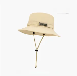 Detail view of beige quick-dry outdoor hat with adjustable drawstring and mountain logo