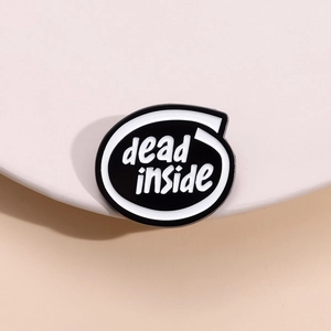 Vue macro de l'épingle en émail minimaliste avec texte dead inside noir et blanc
