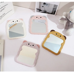 Close-up of cute cartoon bear ear desktop makeup mirrors in soft pastel colors