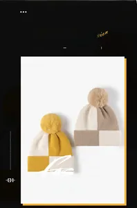 Detail of checkered knit hats with faux fox fur pom poms and ribbed cuffs for winter