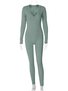 Detail of sage green ribbed knit fabric and deep V-neck on a slim fit long sleeve jumpsuit