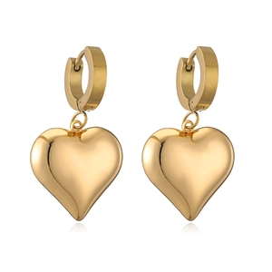 Macro shot of 3D heart-shaped gold earrings with a high-polished metallic finish