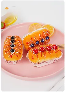Macro view of realistic PU squishy cupcakes with fruit jam toppings and paper liners
