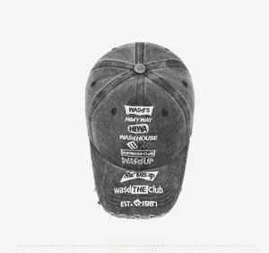 Close-up of vintage washed denim baseball cap with embroidery and distressed brim details
