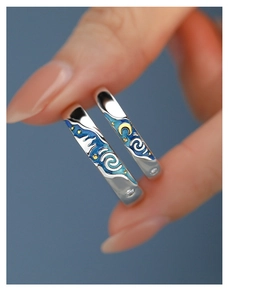 Macro shot of Van Gogh Starry Night couple rings with blue enamel and zircon detail