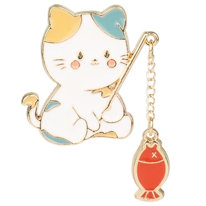 Detail of cute cat fishing enamel brooch with a dangling red fish on a gold chain