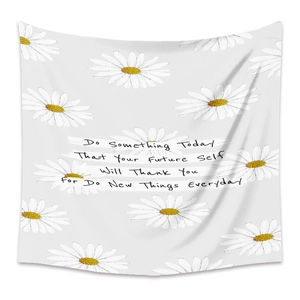 Detail of white daisy floral wall tapestry with motivational text on fabric background