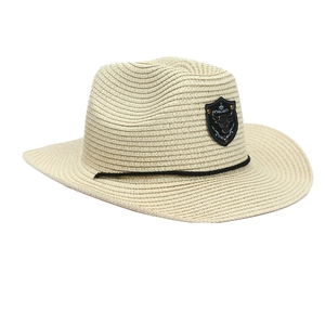 Detail of cowboy straw hat with bull head crest and black rope decoration