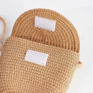 Kids beige straw crossbody bag with velcro closure and natural woven texture detail