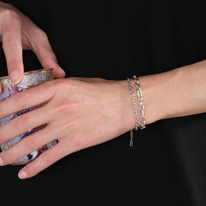 Minimalist double-layered silver titanium steel bracelet worn by a model on a wrist