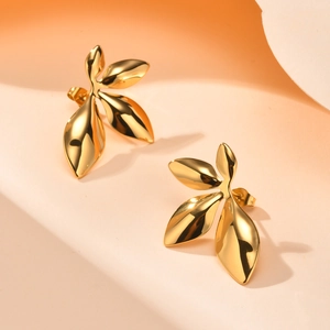 Detailed macro view of 18K gold plated four-leaf clover earrings with polished finish