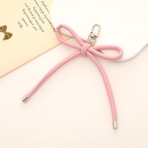 Chic pink leather bow keychain with silver clasp for bags and phone cases