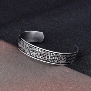 Detailed close-up of retro Viking style stainless steel cuff with Celtic knot patterns