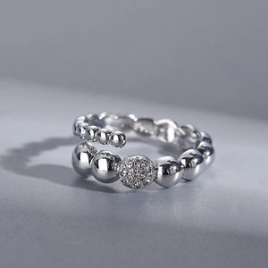 Macro shot of adjustable silver beaded ring with polished metal and pavé cubic zirconia