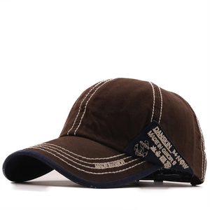 Brown cotton baseball cap with white contrast stitching and embroidered side patch
