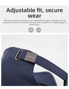 Detailed close-up of adjustable metal buckle on navy blue twill baseball cap strap