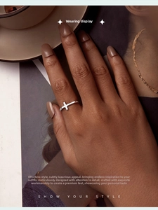 Minimalist S925 sterling silver cross ring shown on a finger in a lifestyle setting