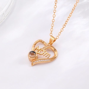 Detailed view of heart-shaped Mom projection necklace with crystals and LOVE YOU engraving