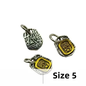 Detailed macro view of retro No. 5 metal deity pendant with dual-tone antique silver finish