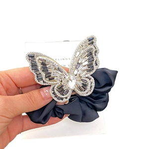 Elegant scrunchie featuring a crystal butterfly pendant with rhinestones on black satin