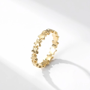 Gold star-shaped stackable titanium steel ring shown from a 45-degree angle
