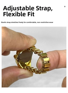 Close-up showing the elastic expansion band of the gold metal finger ring watch