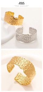 Detail of wide hammer textured 18K gold plated cuff bracelet with irregular wave design