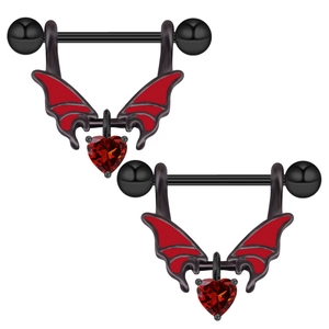 Macro detail of bat wing nipple shields with red enamel and heart-shaped gemstone