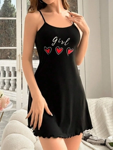 Detail of black camisole nightdress featuring white 'girl' text and red heart print
