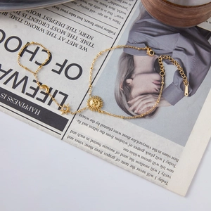 Detailed shot of gold chain bracelet with sun, moon, and star charms with extension