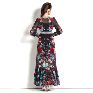 Back view of long floral maxi dress with puff sleeves and layered skirt on a model