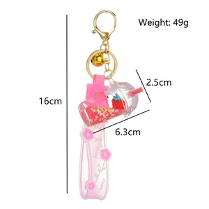Pink milk tea cup acrylic keychain with strawberry floating inside and lucky strap