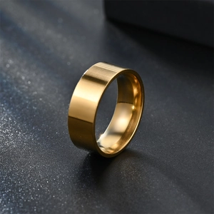 Minimalist 8mm gold polished stainless steel flat ring on a black textured background