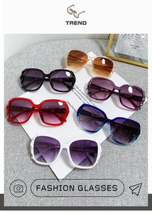 Flat lay of trendy oversized sunglasses featuring diamond-cut frames and gradient lenses